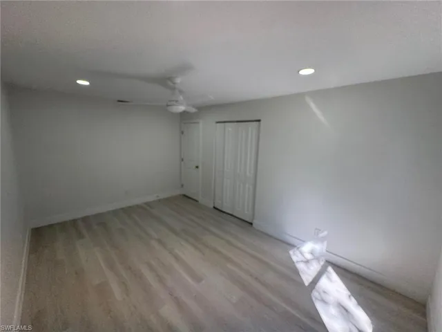 Unfurnished bedroom featuring recessed lighting, a ceiling fan, a closet, light wood-style flooring, and a textured ceiling