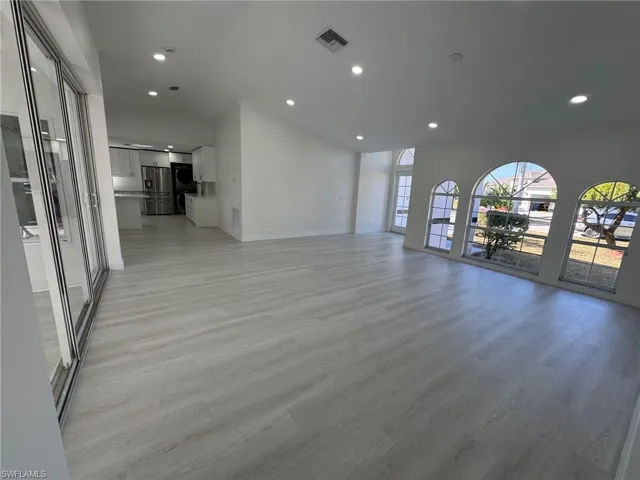 Unfurnished living room featuring light wood-style floors and recessed lighting