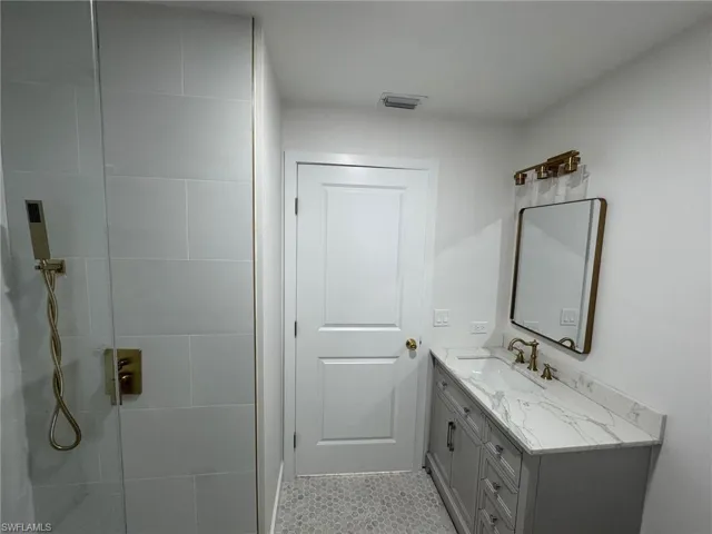 Bathroom featuring vanity and walk in shower
