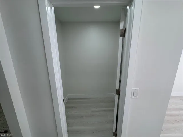 Corridor featuring light wood-style flooring and recessed lighting
