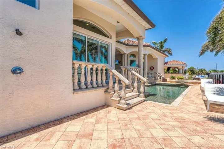 View of swimming pool with a patio area and a pool with connected hot tub