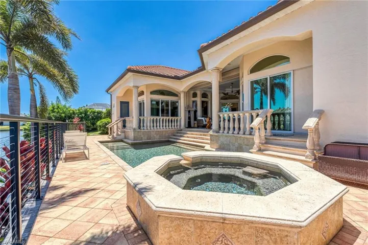 Swimming pool featuring a patio area, an in-ground hot tub, and a ceiling fan