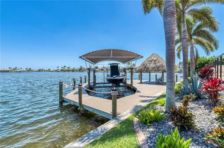 Dock area with boat lift and a water view