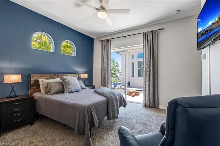 Bedroom with carpet flooring, access to outside, and ceiling fan