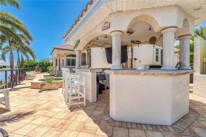 View of patio featuring exterior bar and area for grilling