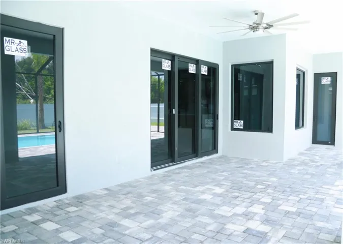 View of patio / terrace with french doors, ceiling fan, and a fenced in pool