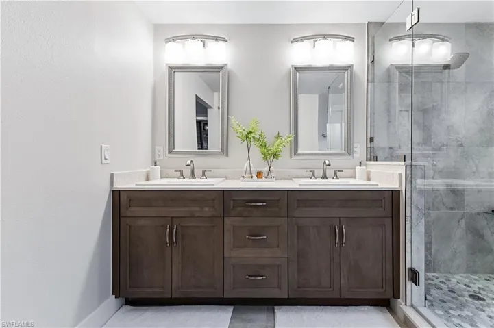 Bathroom featuring vanity and an enclosed shower