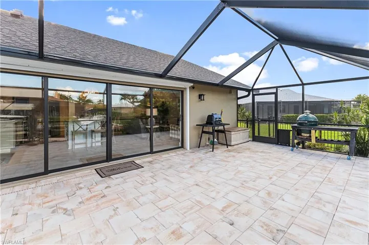 View of patio / terrace featuring a lanai