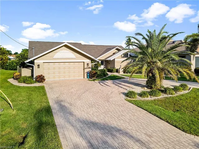 House featuring a front yard and a garage