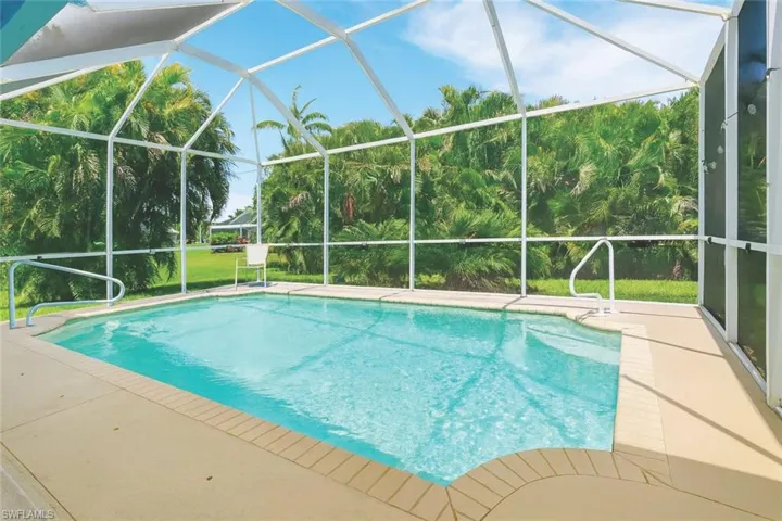 Swimming pool with a sunroom and glass enclosure