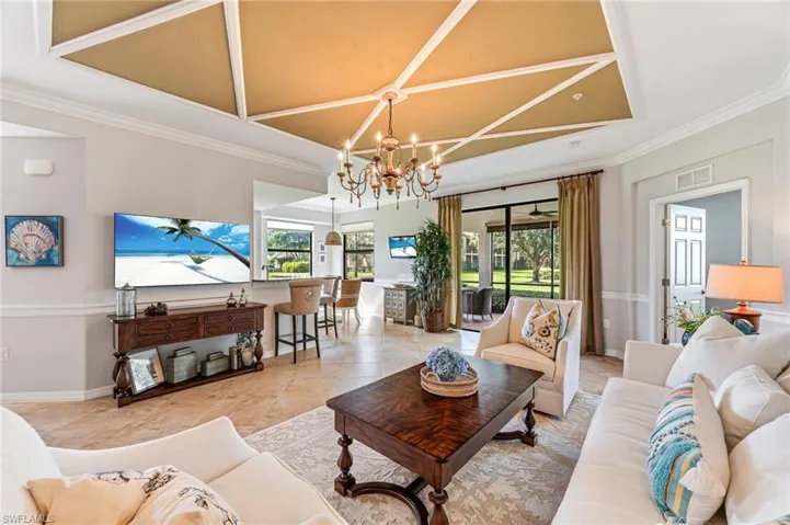 Living room featuring an inviting chandelier and crown molding