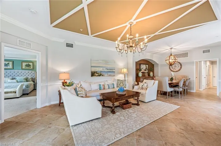 Living room featuring an inviting chandelier and ornamental molding