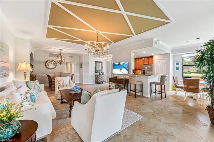 Living room featuring ornamental molding and a chandelier