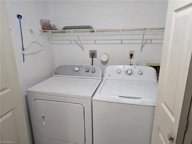 Laundry room with washing machine and dryer, washer hookup, and hookup for an electric dryer