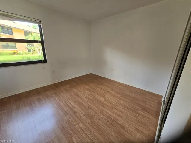 Spare room with hardwood / wood-style flooring