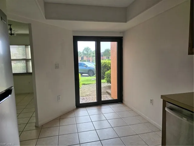 Doorway featuring light tile floors