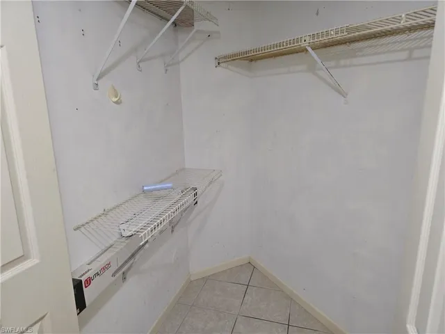 Storage closet with light tile floors