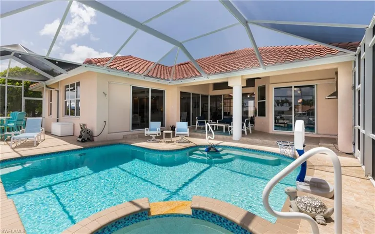 View of swimming pool with a patio and a pool with connected hot tub