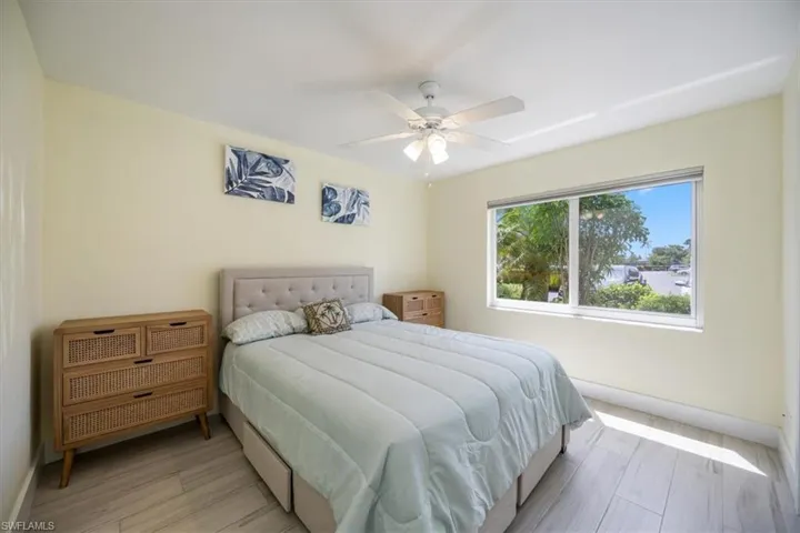 Bedroom with ceiling fan and light wood-type flooring