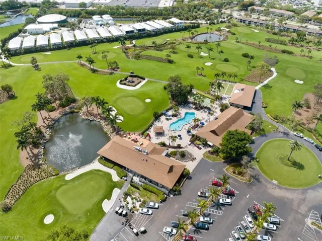 Birds eye view of property with a water view