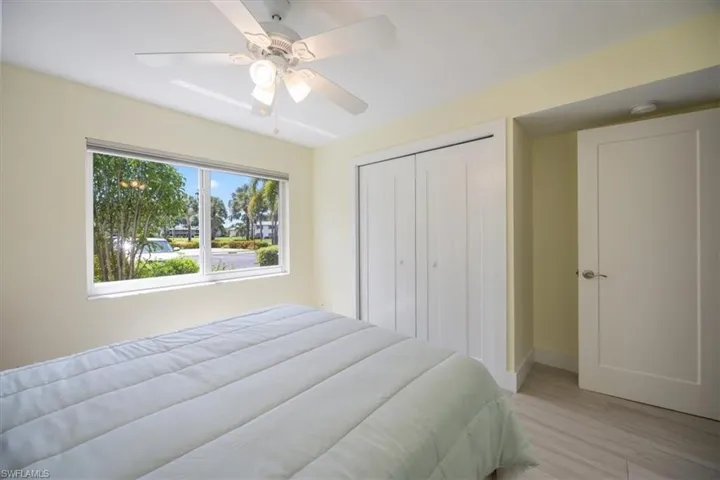 Bedroom featuring light wood-type flooring, a closet, and ceiling fan