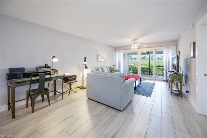 Living room with light wood-type flooring and ceiling fan