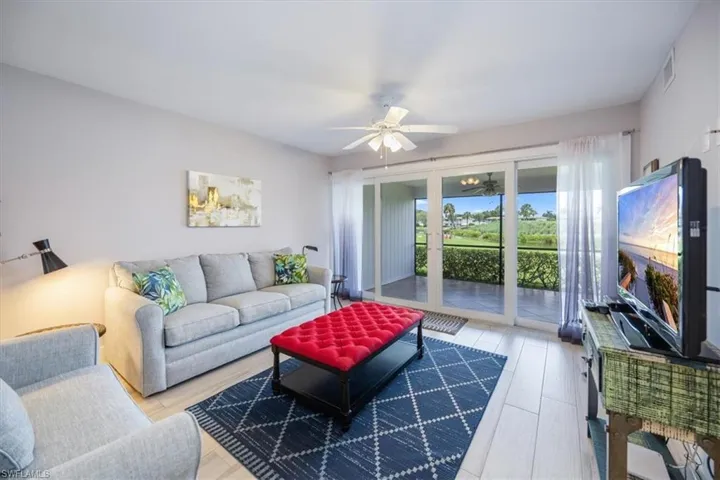Living room with light hardwood / wood-style flooring and ceiling fan