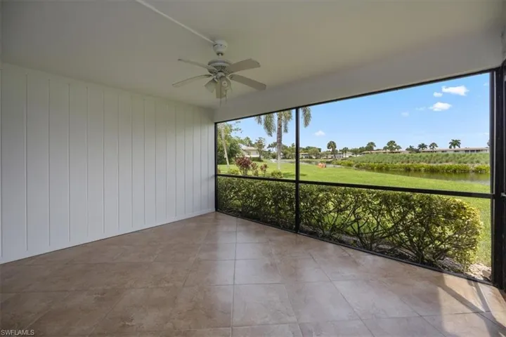 Unfurnished sunroom with ceiling fan and a water view