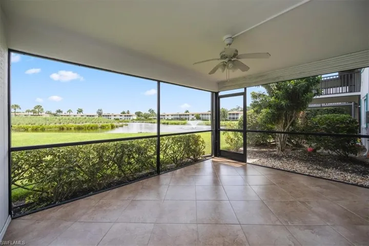 Unfurnished sunroom featuring a water view and ceiling fan