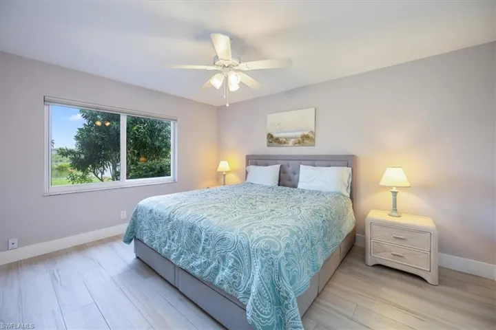 Bedroom with ceiling fan and light hardwood / wood-style floors
