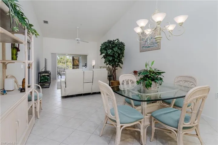 Vaulted ceiling enhances this open living space featuring ceramic tile flooring