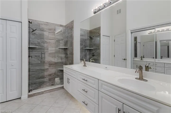 Dual vanity with undermount sinks, brushed nickel faucets, and a full-width mirror