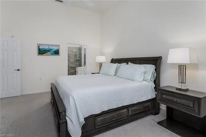 Carpeted room featuring a vaulted ceiling and a ceiling fan