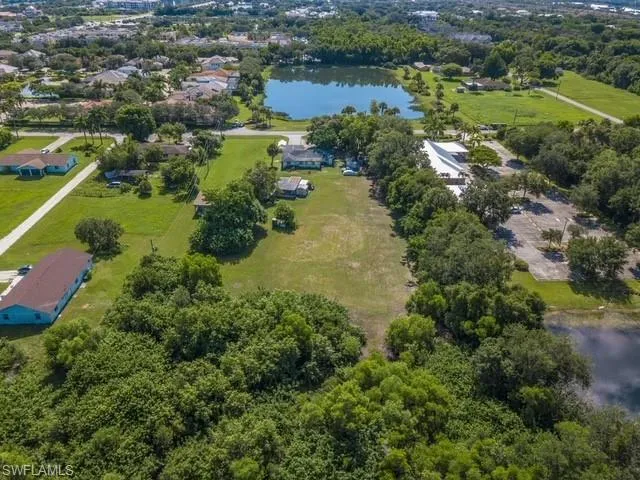 Birds eye view of property with a water view