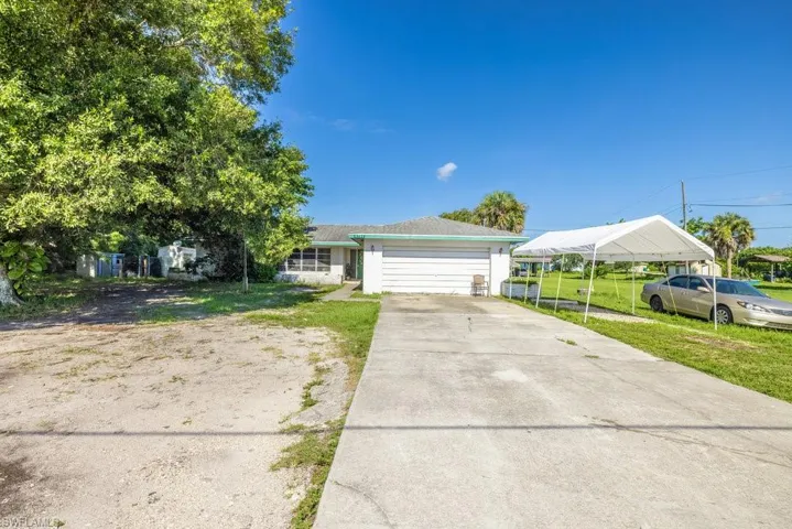 View of front of home featuring a garage and a front lawn