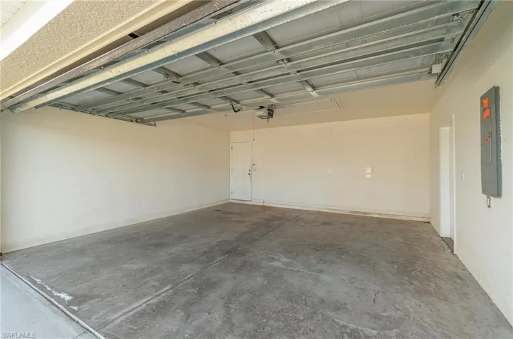 Garage with electric panel and a garage door opener