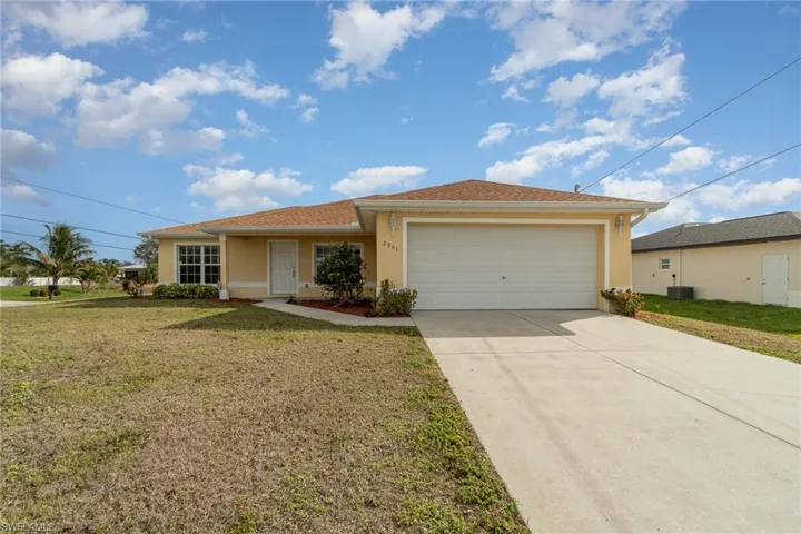 Ranch-style house featuring a front yard, central AC, and a garage