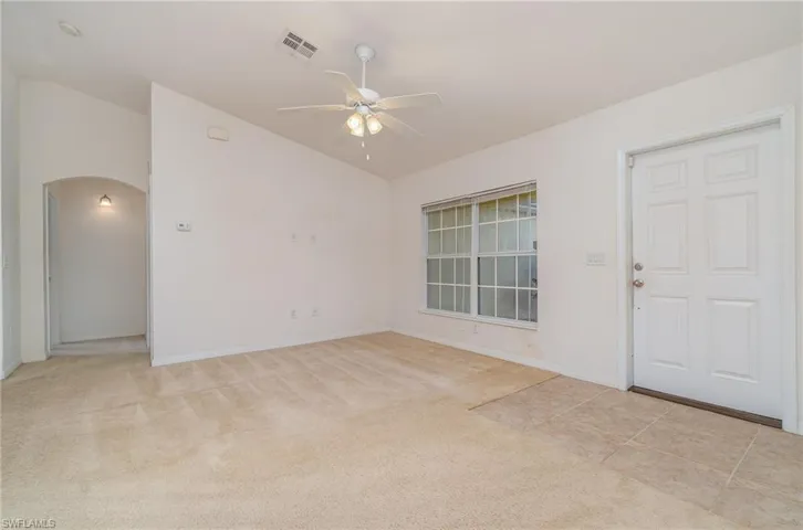 Carpeted empty room with ceiling fan