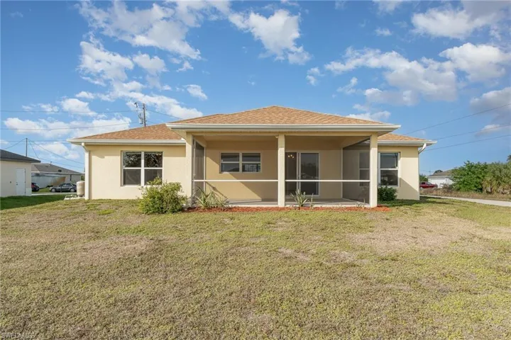 Back of house featuring a yard and a patio