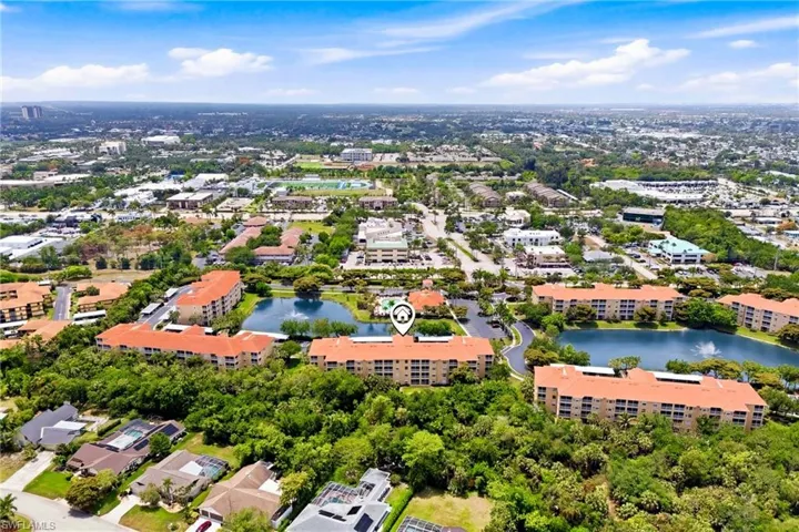 Aerial view of the building showcasing its prime location within a well-maintained Fort Myers community surrounded by lush landscaping and peaceful surroundings.