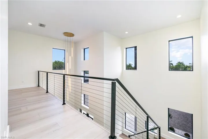 Corridor featuring an upstairs landing, recessed lighting, and light wood-type flooring