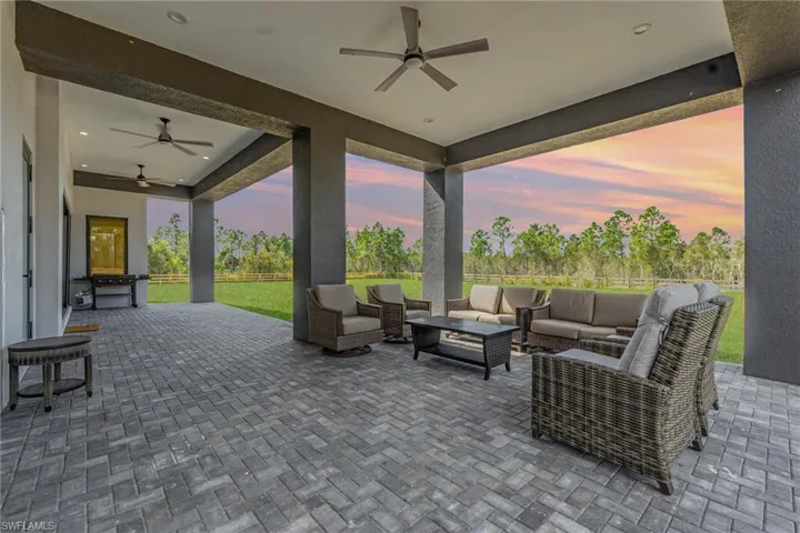 Patio terrace at dusk with a ceiling fan and a patio