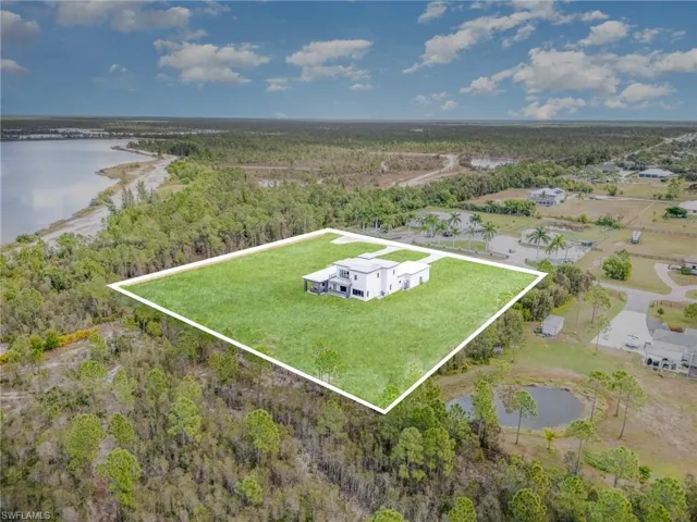 Aerial overview of property's location with a nearby body of water and property boundaries highlighted