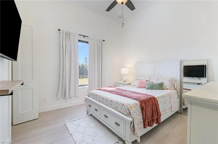 Bedroom with light wood finished floors and ceiling fan