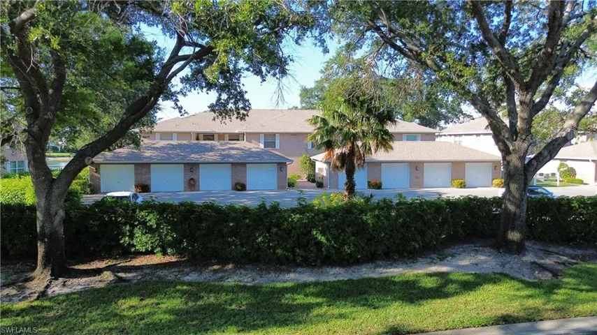 View of front of property featuring a front yard and a garage