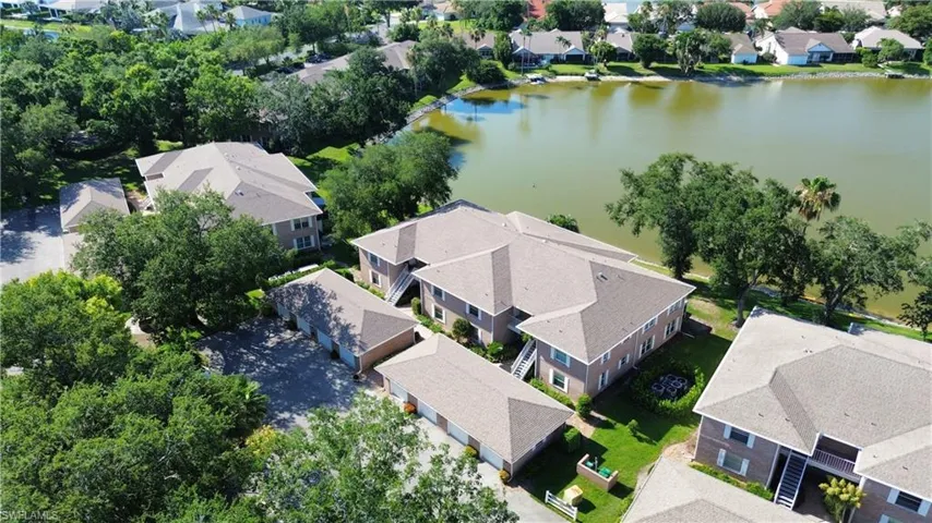 Birds eye view of property with a water view