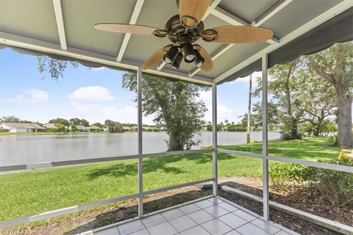 Unfurnished sunroom with a water view and ceiling fan