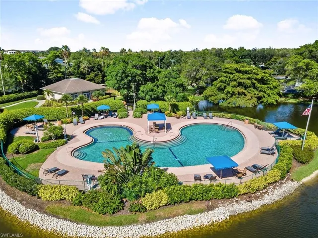 View of pool with a patio and a water view