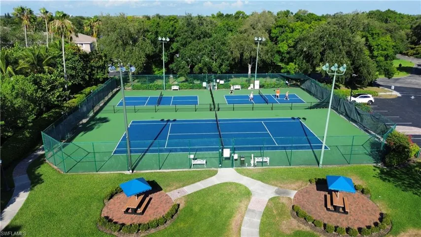 View of sport court with a lawn