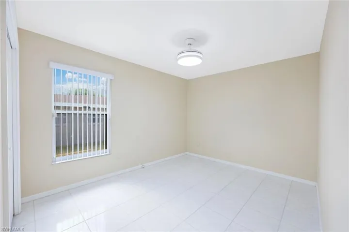 Unfurnished room with light tile patterned floors